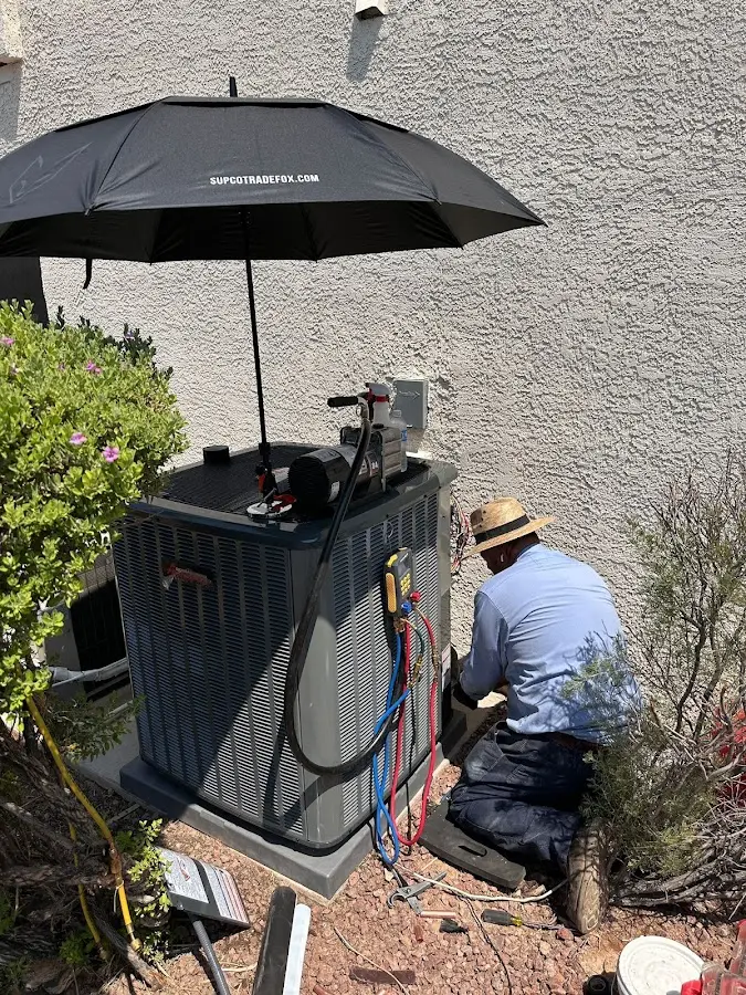 HVAC technician performing outdoor AC maintenance in Newport
